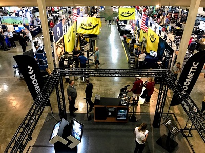 A photo taked from above showing people milling around booths at the RV/MH Hall of Fame Supplier Show