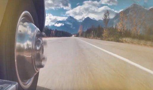 Close-up view of RV wheels rolling down mountain highway