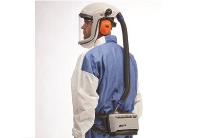 A picture of a man wearing a 3M Powered Air Purifying Respirator