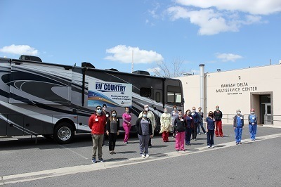 A photograph of medical staff from Kaweah Delta Multiservice Center standing in front of a motorhome donated by RV Country in Fresno, California.