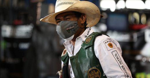 A photo of a professional bull rider wearing a protective face mask